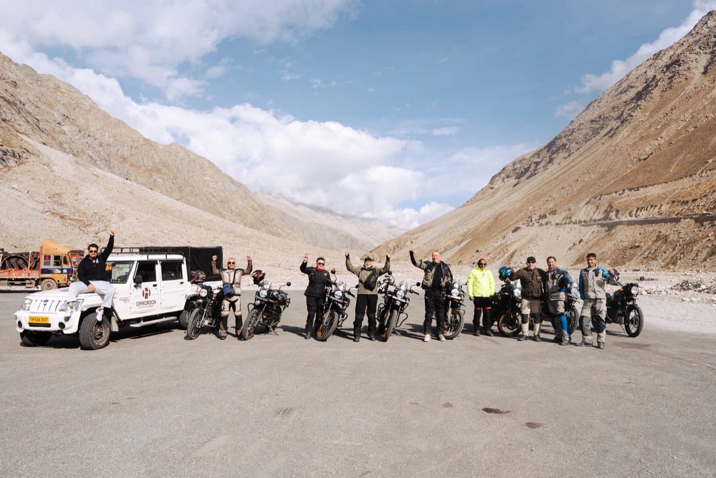 Offhorizon Adventures group with the support vehicle and motorcycles lined up in the Lahaul valley on the morning of Day 4