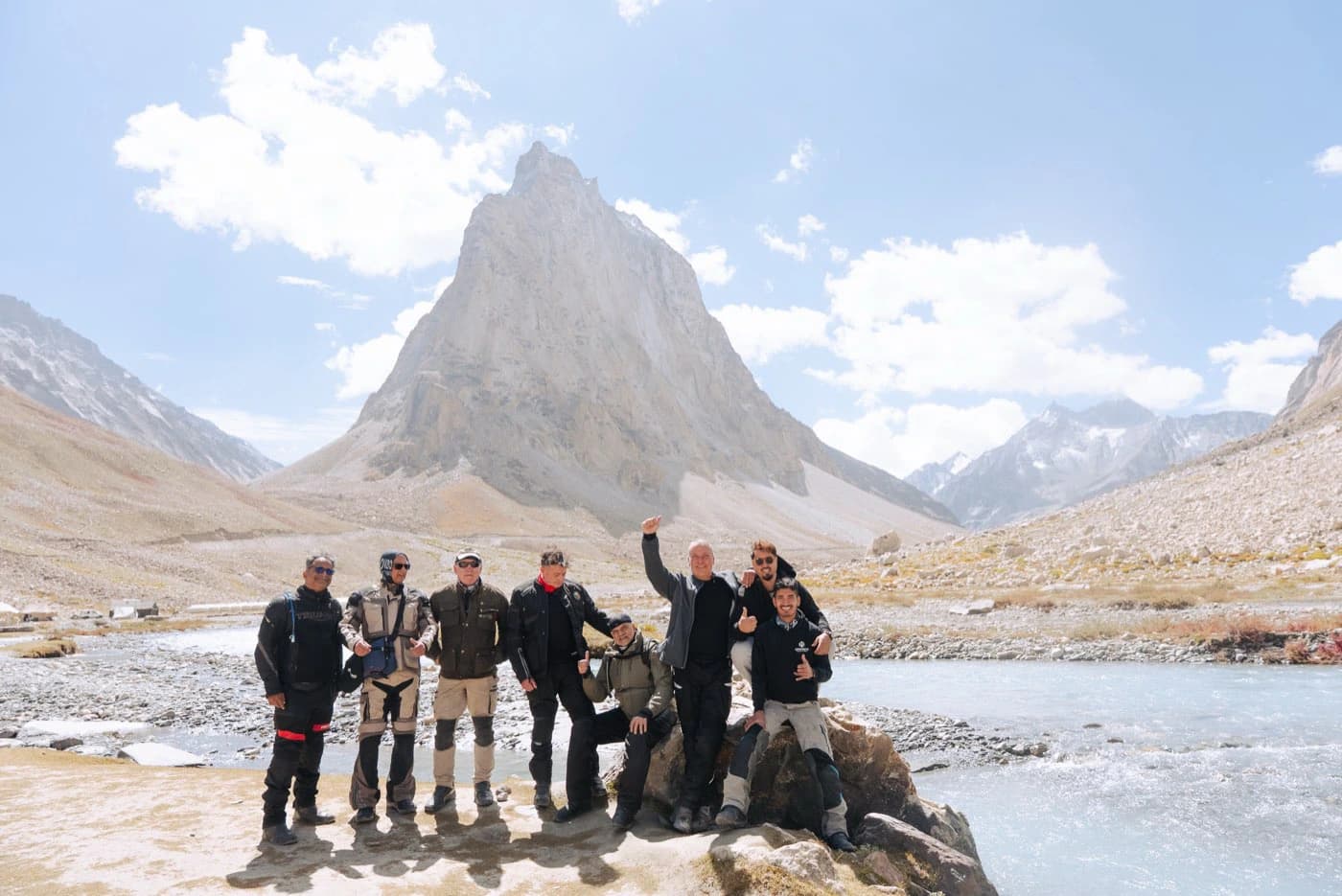Group of motorcycle riders by the river at the foot of Gonbo Rangjon at 5,520 m