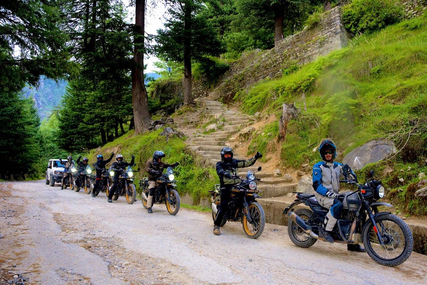Riders on Royal Enfield Himalayan 450 motorcycles lined up on the road out of Manali on Day 2
