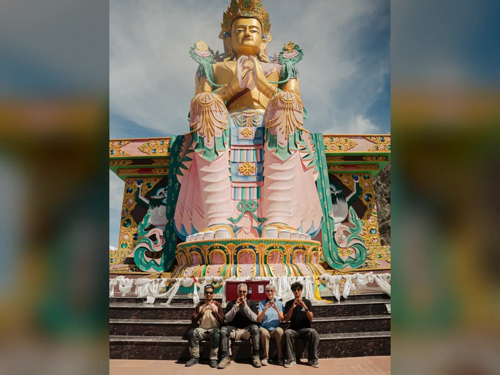 Riders beneath the giant Maitreya Buddha statue at Diskit Monastery, Nubra Valley