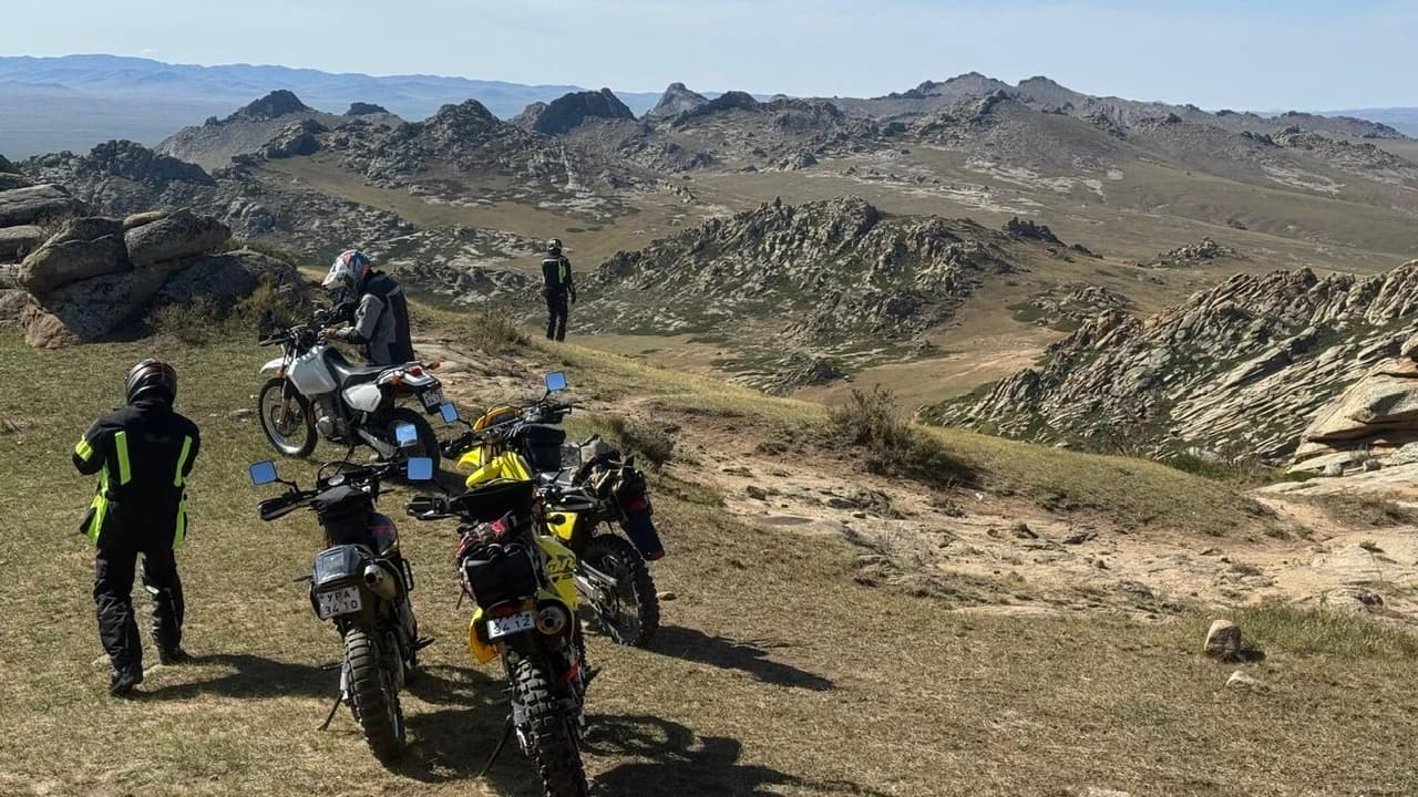 Motorcycles parked on a ridge above rocky hills in central Mongolia