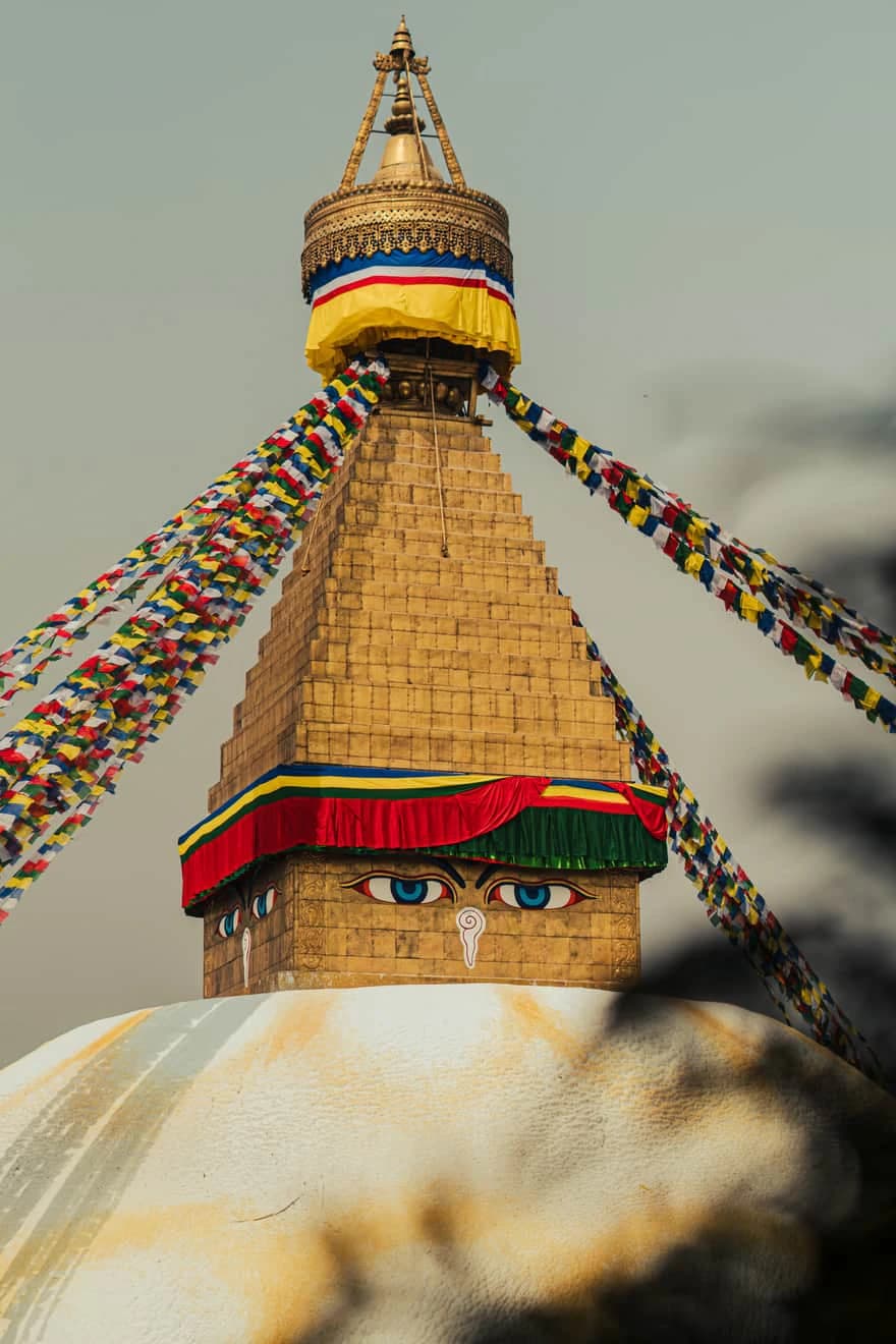 Boudhanath Stupa in Nepal decorated with colorful Buddhist prayer flags