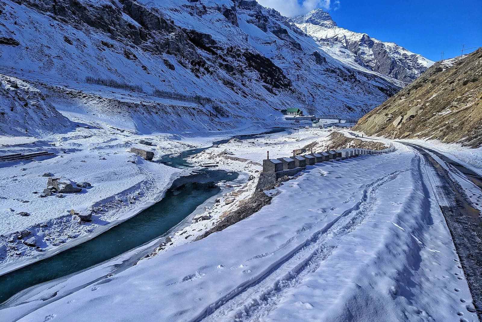 Snow-packed Himalayan road running beside a river gorge — the Hindustan-Tibet Road in winter