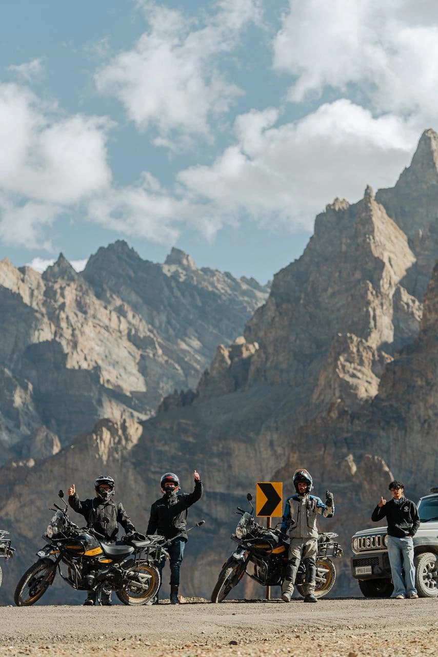 A group of motorcycle riders with Royal Enfield Himalayan motorcycles exploring the rugged landscapes around Padum in the Zanskar Valley, Ladakh. Padum is the main town and an important stop for motorcycle expeditions through the remote Zanskar region.