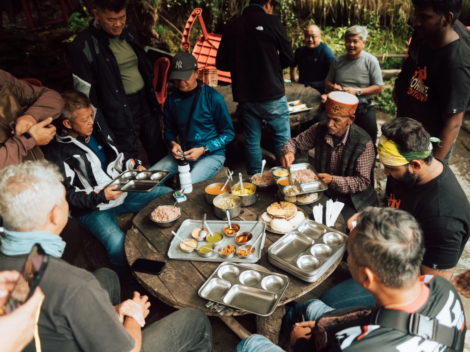 Travelers sharing a local meal together during a Ladakh adventure