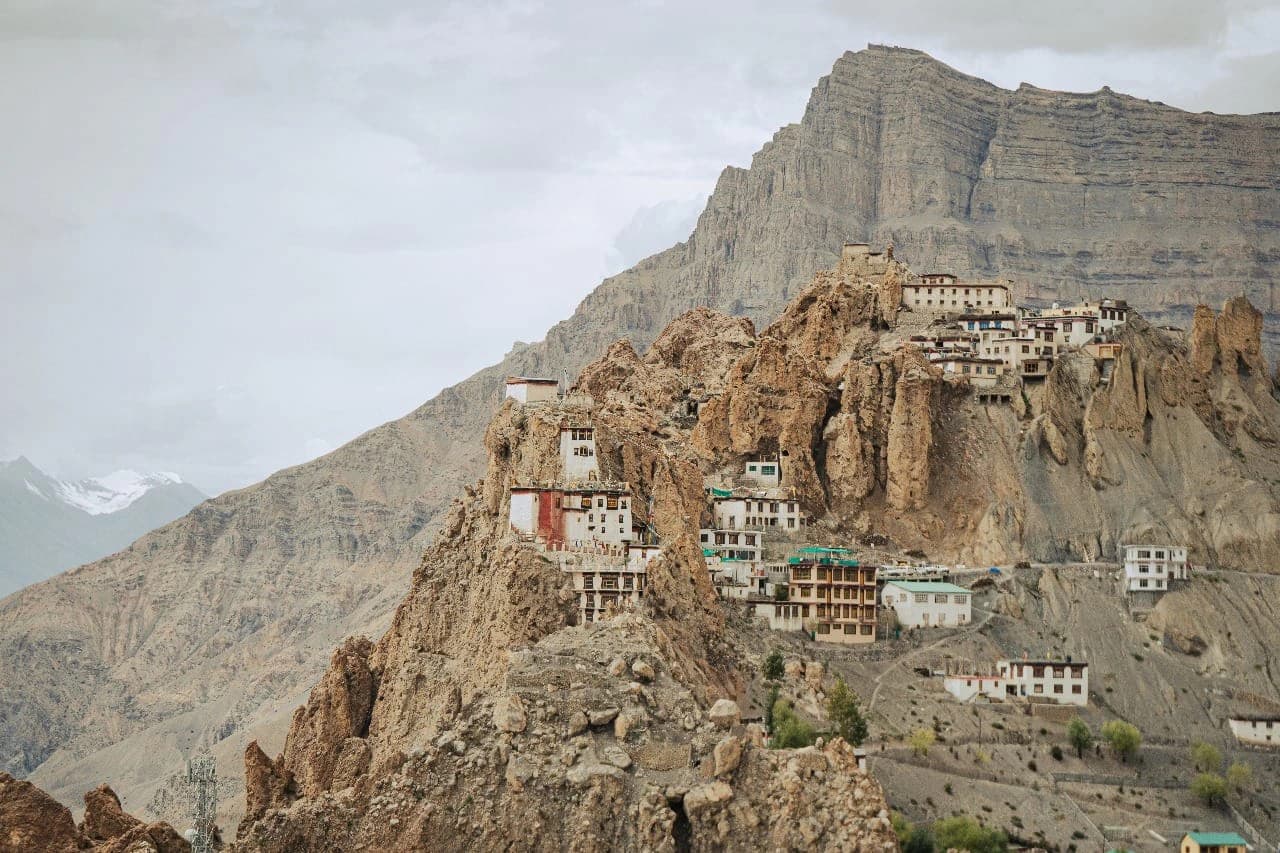Remote Himalayan village surrounded by rugged mountain valleys